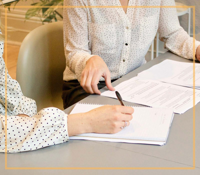 two meeting planners signing a contract