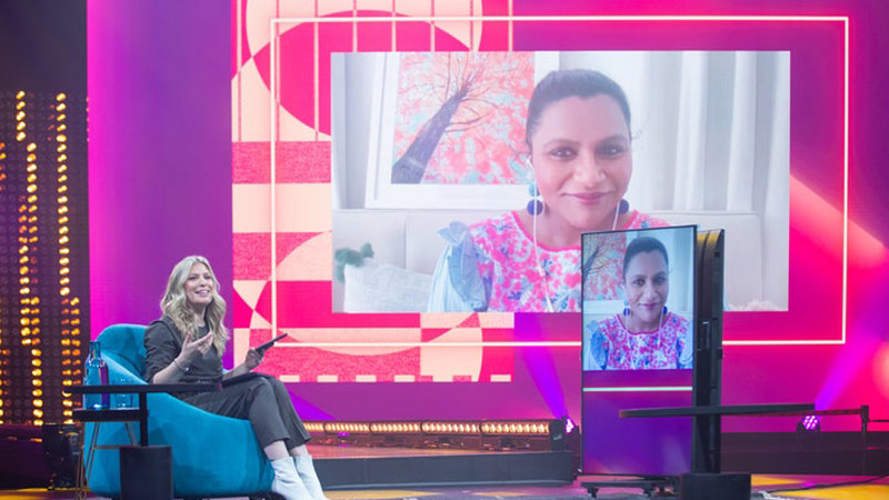 mindy kaling as a remote speaker onstage at hybrid event